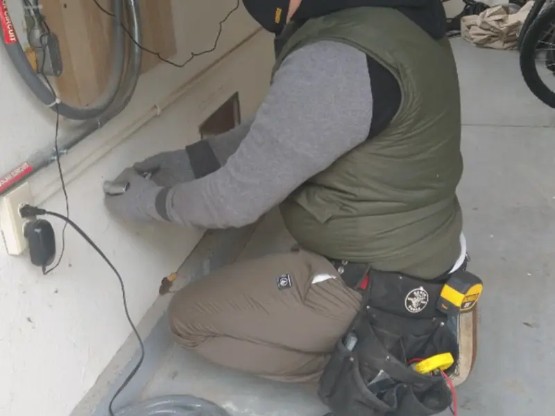 Electrician performing outlet wiring in a La Puente garage